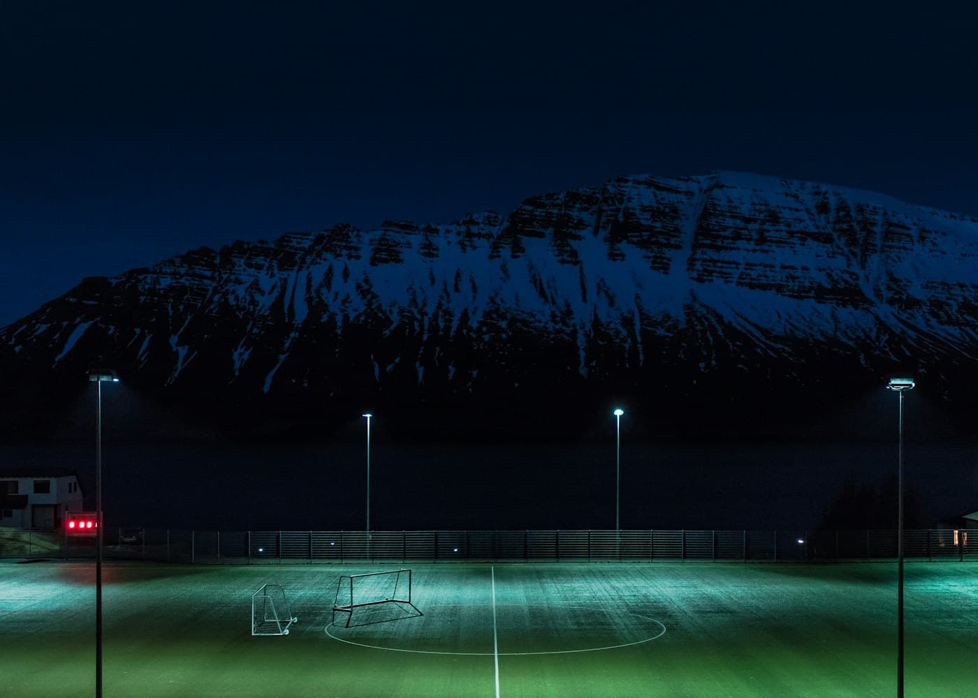 Players on a pitch at dusk